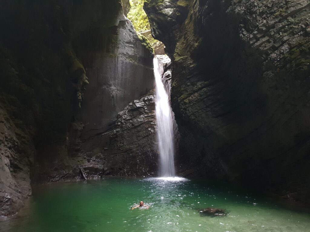 Cascada de Kozjak en Kobarid con poza turquesa y persona nadando, Eslovenia