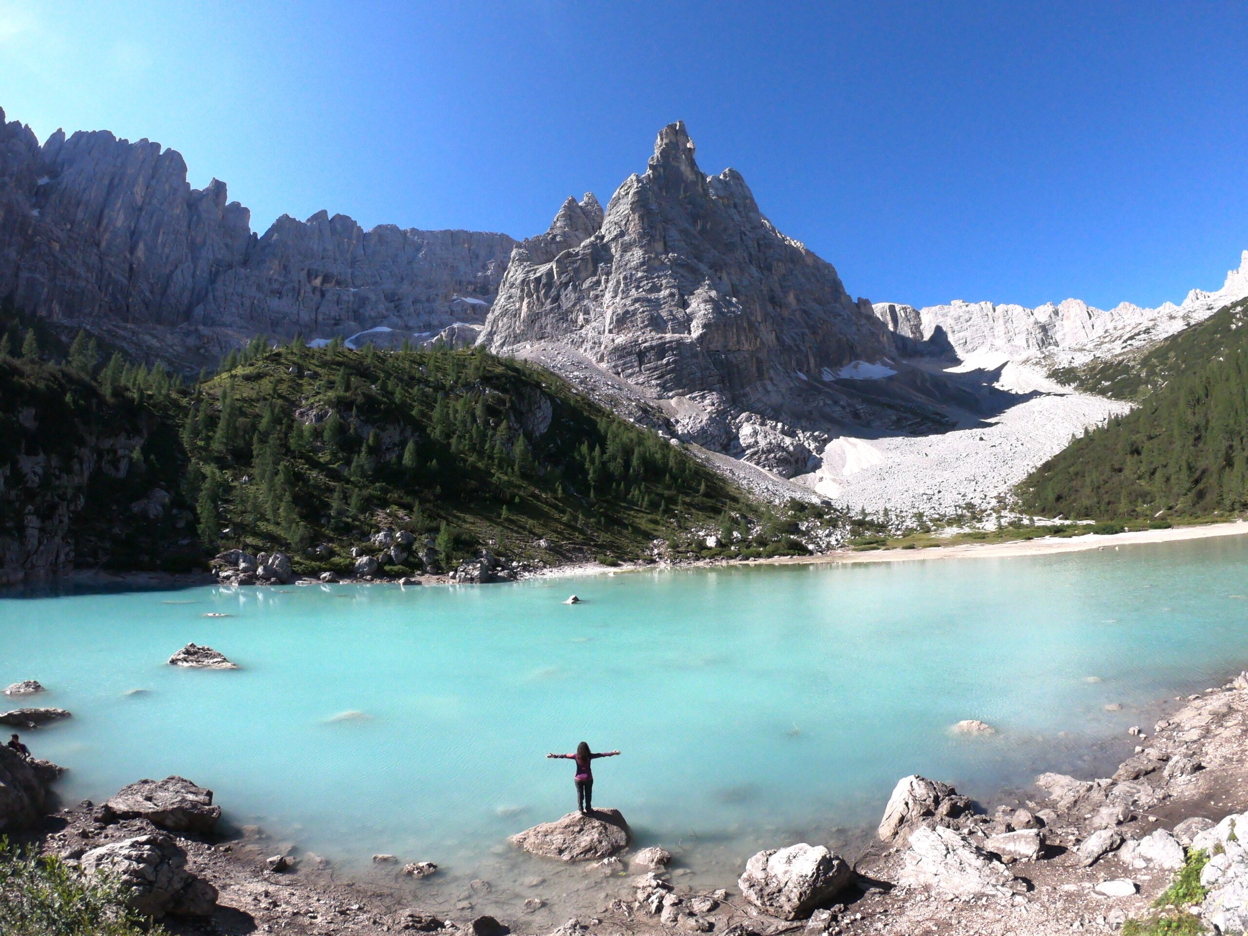 Mujer frente al lago di sorapis en Dolomitas, Italia